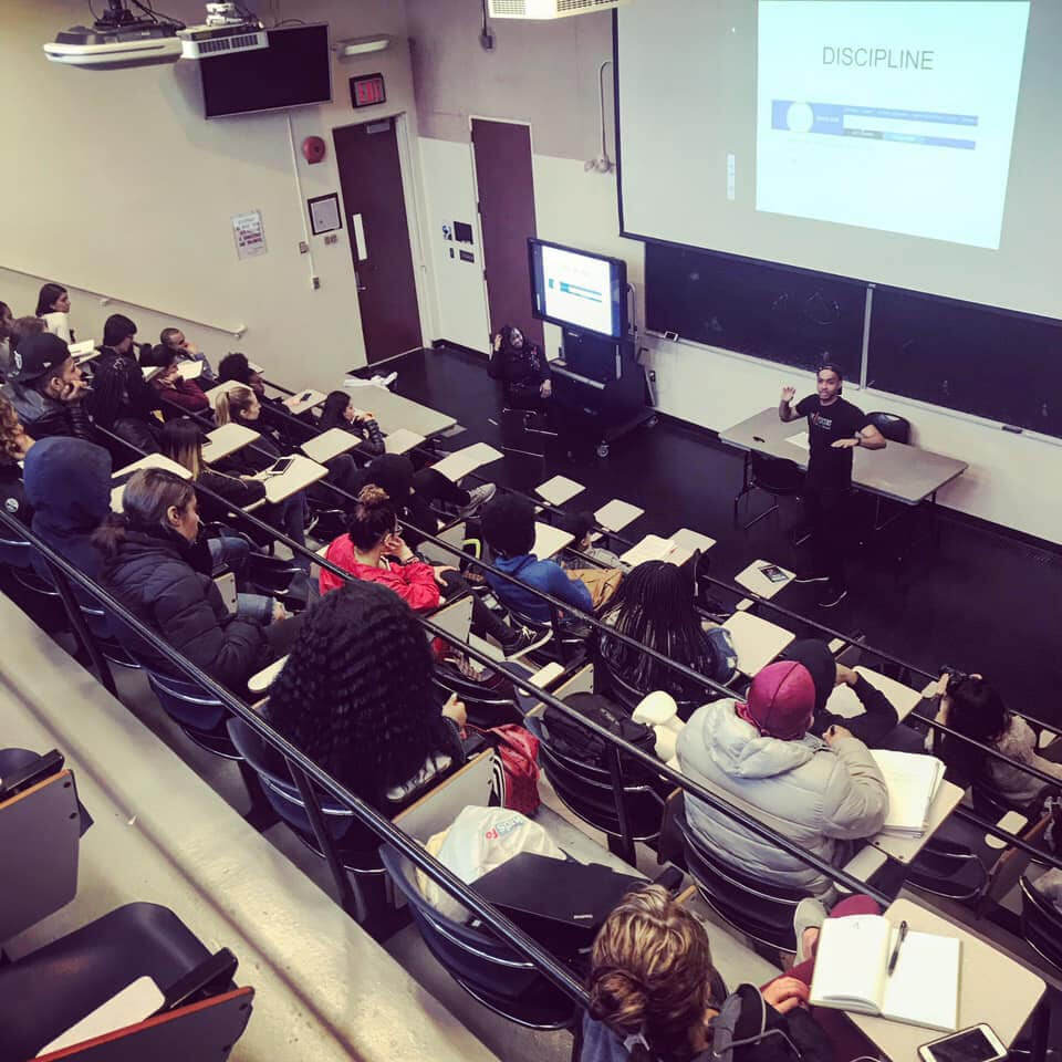 Michael Ducille teaching a lecture hall full of students