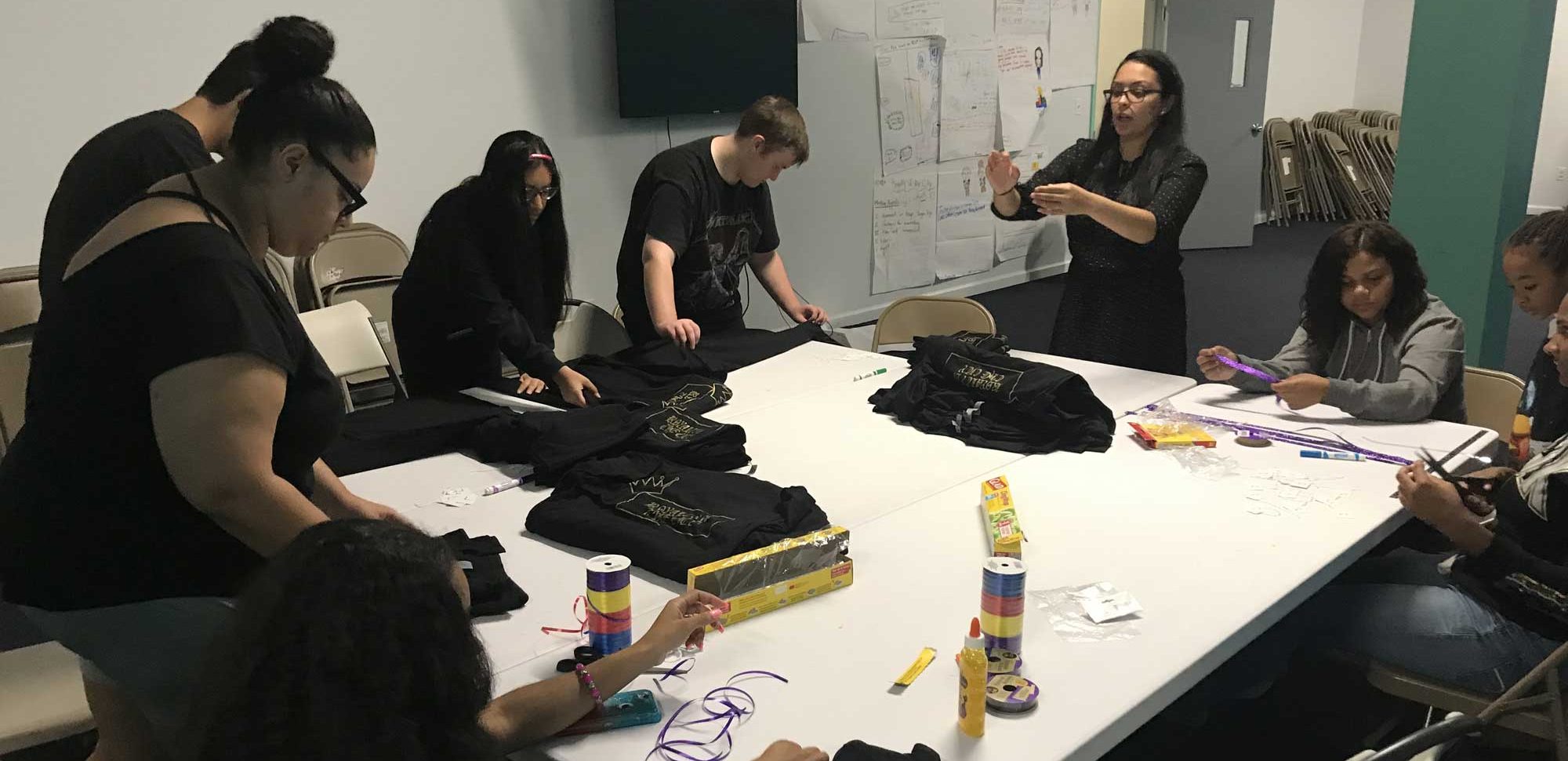 Students working together on their business at a workshop table